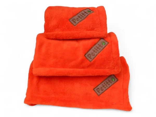 Folded orange blankets for pets
